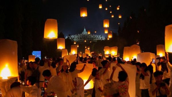 This picture taken on June 4, 2023 shows Buddhist devotees releasing lanterns during Vesak day at Borobudur temple in Magelang, Central Java. (Photo by DEVI RAHMAN / AFP) (Photo by DEVI RAHMAN/AFP via Getty Images)