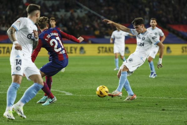 Girona's Miguel Gutierrez scores his side's second goal during the Spanish La Liga soccer match between Barcelona and Girona at the Olimpic Lluis Companys stadium in Barcelona, Spain, Sunday, Dec. <div class=
