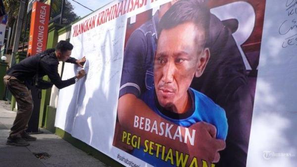 KASUS VINA CIREBON - Warga membubuhkan tandatangan di banner atau spanduk yang dipasang Sahabat Pegi bergambar foto Pegi Setiawan dan bertuliskan Bebaskan Pegi Setiawan sebagai bentuk dukungan saat persidangan perdana praperadilan tersangka Pegi Setiawan di Pengadilan Negeri (PN) Bandung, Jalan LLRE Martadinata, Kota Bandung, Jawa Barat, Senin (24/6/2024). Susno Duadji mengatakan Polda Jabar harus legowo jika nanti terbukti kalah di sidang praperadilan Pegi Setiawan, kenapa?