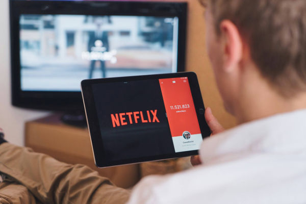 Ilustrasi seseorang menggunakan layanan Netflix. Foto: Unsplash.com
