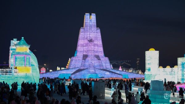 Foto yang diambil pada 21 Desember 2024 ini menunjukkan orang-orang yang mengunjungi Festival Dunia Es dan Salju Harbin di Harbin, provinsi Heilongjiang, Tiongkok timur laut. - Festival tahunan edisi ke-26 secara resmi dibuka pada tanggal 21 Desember di Harbin, yang juga dikenal sebagai 