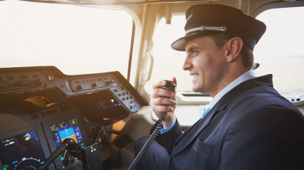 Pilot smiling while talking on radio