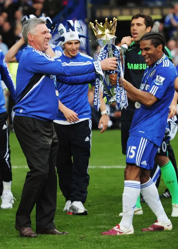 LONDON, ENGLAND - MAY 09: Manager Carlo Ancelotti and Florent Malouda of Chelsea celebrate with the trophy after the Barclays Premier League match between Chelsea and Wigan Athletic at Stamford Bridge on May 9, 2010 in London, England. <div class=