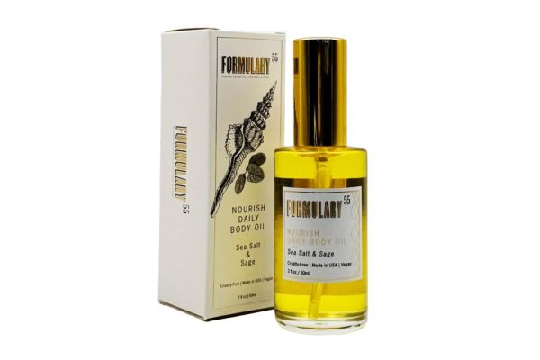 A bottle of body oil with its packaging box