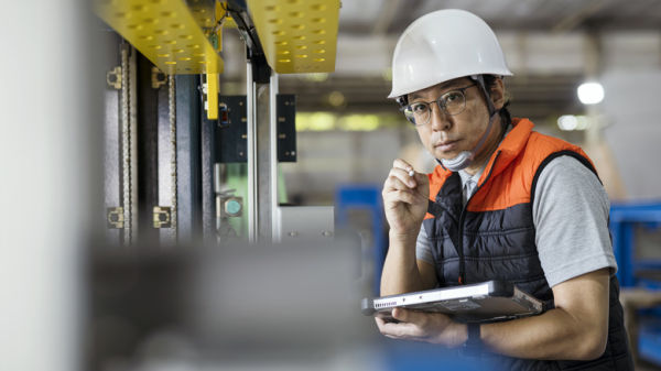 factory worker taking notes
