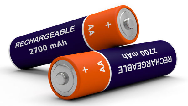 Two rechargeable batteries on a white surface. The second battery is resting on the first. They are dark blue and orange in color and display the words 