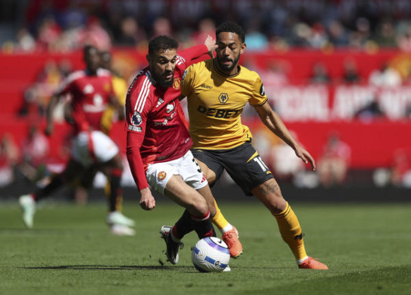 Pemain Manchester United, Noussair Mazraoui, beraksi dengan pemain Wolverhampton Wanderers, Matheus Cunha pada pertandingan Liga Inggris antara Manchester United vs Wolverhampton Wanderers di Old Trafford, Manchester, Inggris, Minggu (20/4/2025). Foto: Scott Heppell/REUTERS