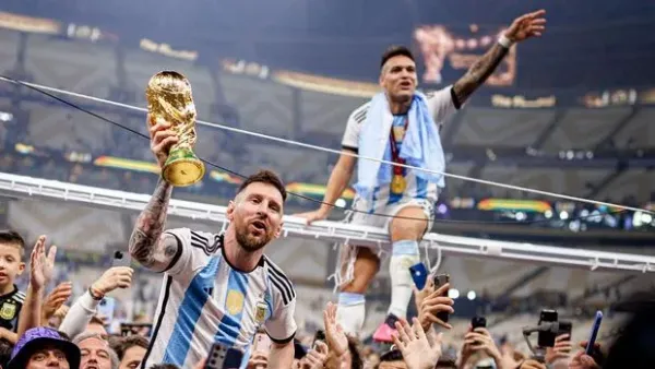 LUSAIL CITY, QATAR - DECEMBER 18: Lionel Messi of Argentina lifts the Fifa World Cup Trophy with Lautaro Martinez after winning the FIFA World Cup Qatar 2022 Final match between Argentina and France at Lusail Stadium on December 18, 2022 in Lusail City, Qatar. (Photo by MB Media/Getty Images)