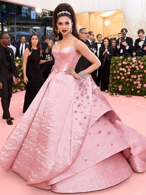 Image may contain Mastani Clothing Dress Fashion Formal Wear Gown Wedding Wedding Gown Adult Person and Footwear