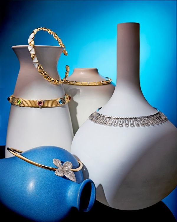 Image of silver and gold chokers on vases