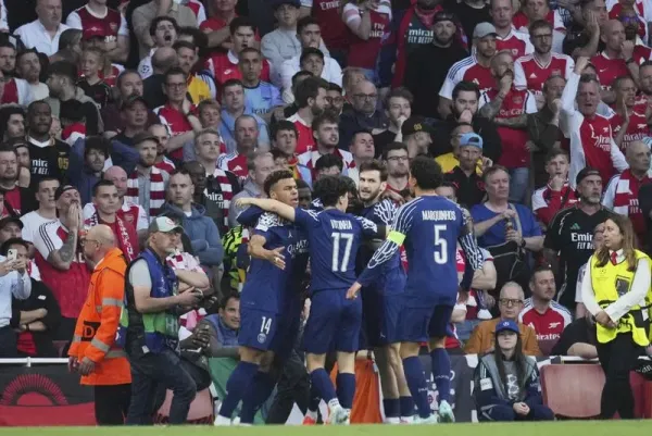 PSG players celebrate after Ousmane Dembele scored the opening goal during the Champions League semifinal first leg soccer match between Arsenal and Paris Saint-Germain at Arsenal Stadium in London, England, Tuesday, April 29, 2025. (AP Photo/Kin Cheung)