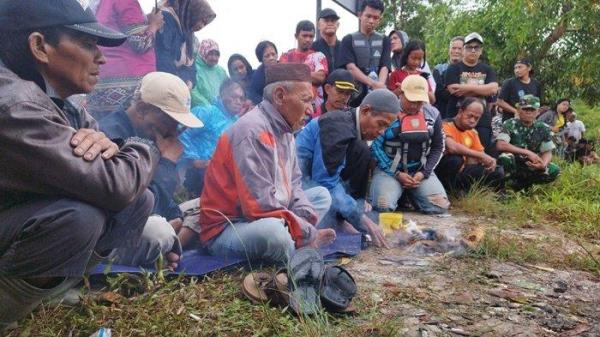 RITUAL DUKUN ADAT - Suasana dukun adat yang sedang melakukan ritual untuk pencarian hilangnya pemuda Dino (21), di tepi Sungai Manggar, Kabupaten Belitung Timur, Pada Jumat (9/5/2025).