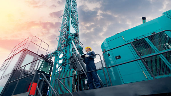 Oil rig staff member holding tablet