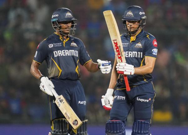 Gujarat Titans’ captain Shubman Gill celebrates his half century with Sai Sudharsan during an Indian Premier League (IPL) 2025 T20 cricket match between Delhi Capitals and Gujarat Titans, at the Arun Jaitley Stadium.