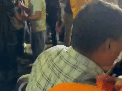 Family members carrying the injured girl in the stampede and taking away from the crowd.