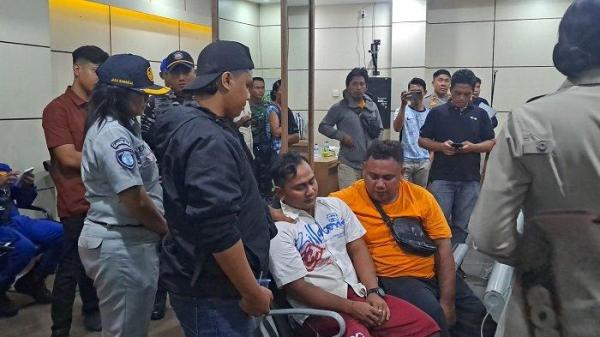 TANGIS - Febriani tak kuasa menahan tangis setelah melihat jenazah istrinya bernama Cahyani, yang baru tiba di Posko ASDP Gilimanuk. Ia bersama istrinya menumpang KMP Tunu namun terpisah saat di laut.