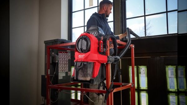 A person using Milwaukee's 3-in-1 Backpack Vacuum in hang mode
