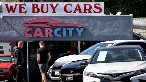 Car City used car dealership with We Buy Cars banner