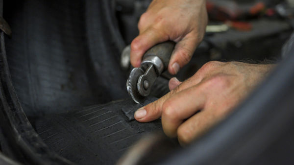 Mechanic installing tire patch