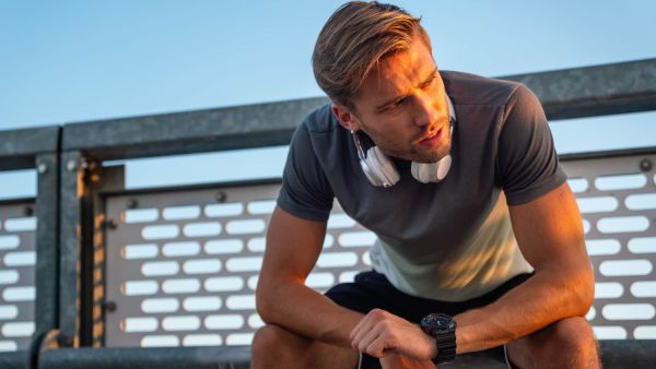 Man who struggles to recover after workouts sitting outside.