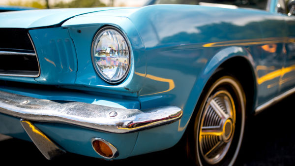 Close-up view of a blue Ford Mustang.