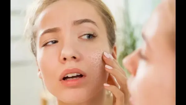 A woman touching her cheek, with a circular magnifying insert over her eye and cheek showing severely dry, cracked, and dehydrated skin texture