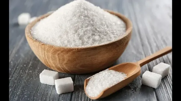 bowl of sugar and sugar cubes with full of sugar spoon