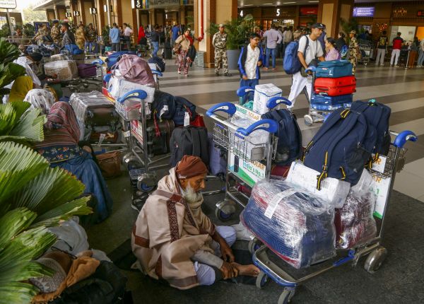 Elderly people were seen sitting with luggage at Ahmedabad airport.