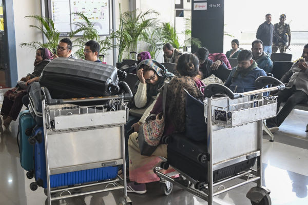 Passengers sitting waiting for flight at Patna airport.