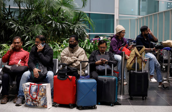Passengers were seen sitting at Delhi airport after the flight was cancelled.