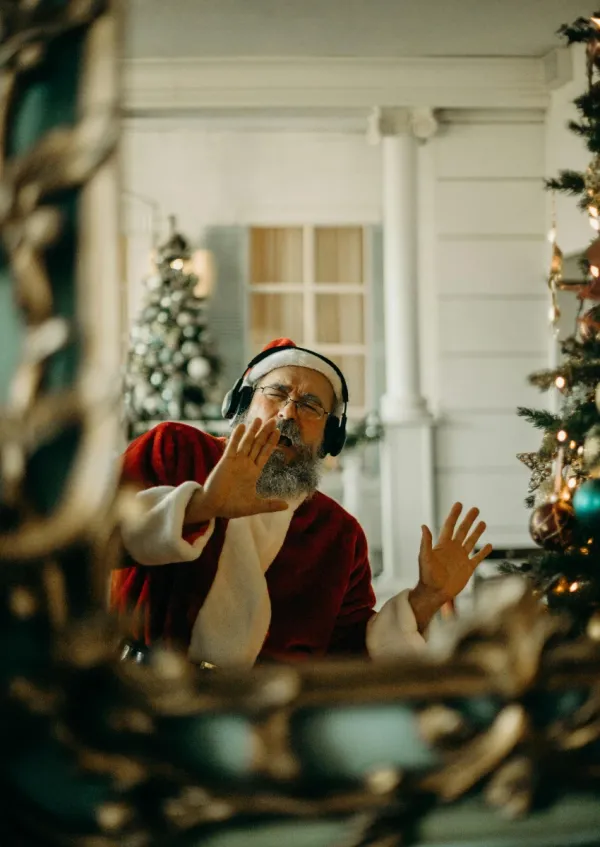 man dressed like Santa listening to music at Christmas