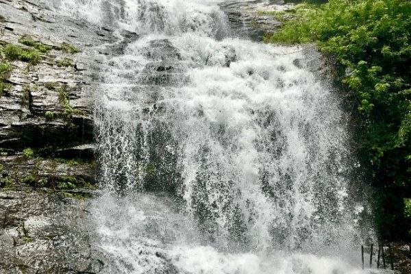 This may contain: a large waterfall with water cascading down it's sides