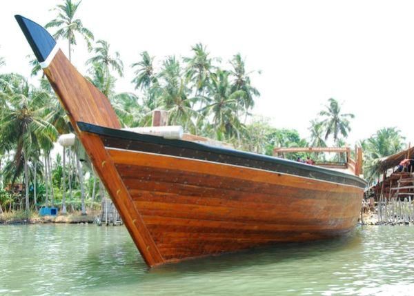 This may contain: an old wooden boat in the water