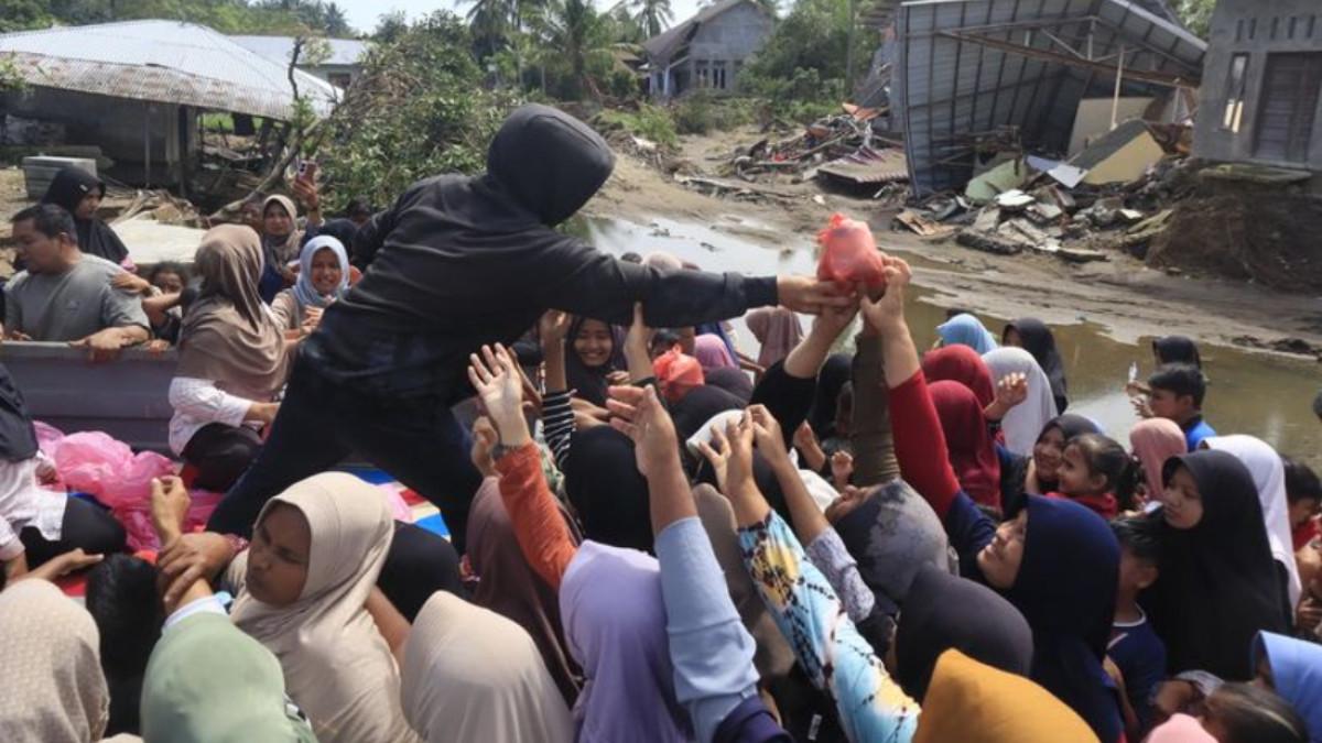 Sejumlah pelajar menerima bantuan makanan siap saji di lokasi pengungsian Desa Bungkah, Kecamatan Muara Batu, Kabupaten Aceh Utara, Sabtu (20/12/2025).