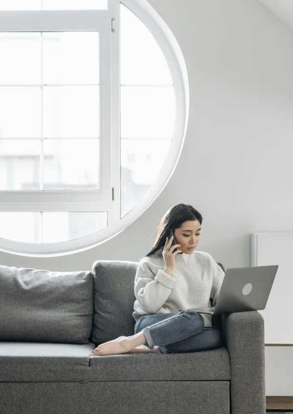 woman experiencing digital burnout because she's on her phone and laptop at the same time