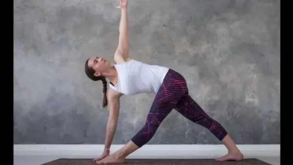 A woman performing Trikonasana (Triangle Pose)