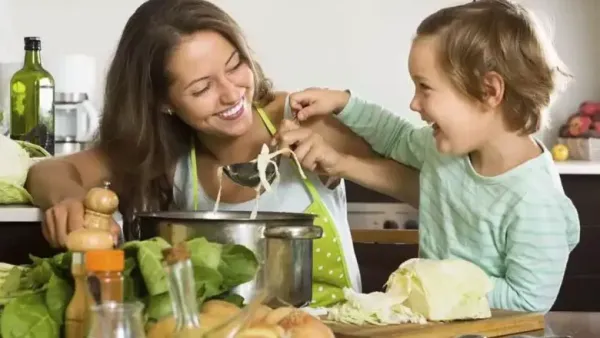 woman playing with her child in kitchen