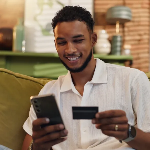 man ordering on phone holding credit card