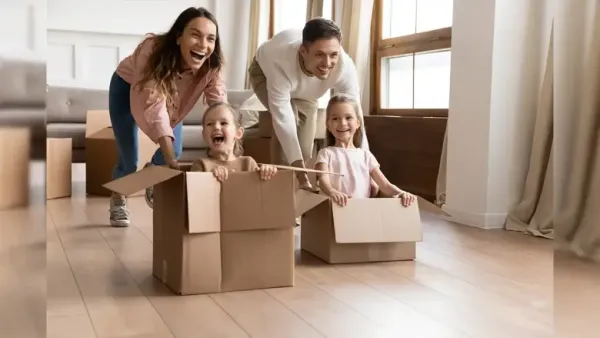 Parents playing with their kids who are sitting in box