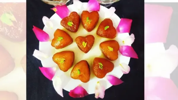 heart shaped gulab jamun arranged in a plate with reose petals
