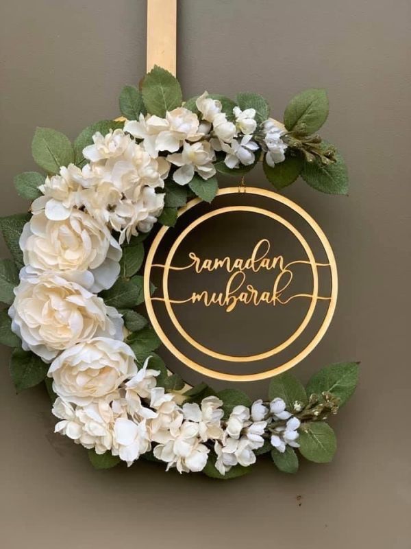 This may contain: a wreath with flowers hanging on the wall