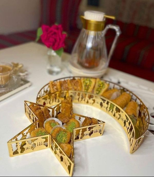 This may contain: some food is sitting on a table with a vase and tea pot in the background