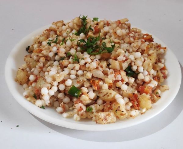 This may contain: a white plate topped with corn and vegetables