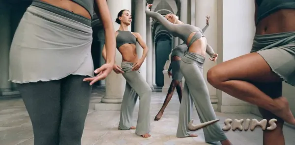 Collage of multiple people modeling Nike X Skims clothing.