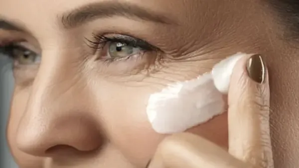 wrinkled face woman applying moisturizer on face
