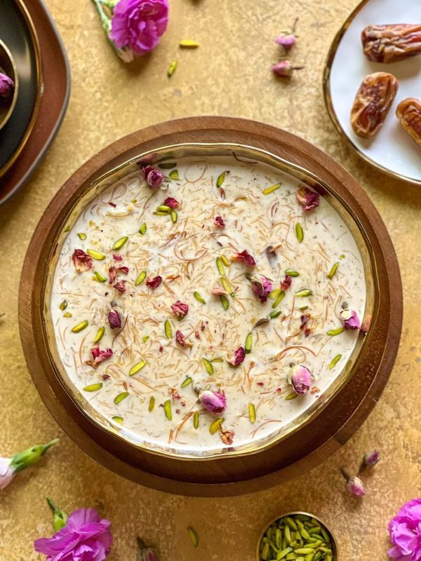 This may contain: a bowl filled with food sitting on top of a table next to other bowls and spoons