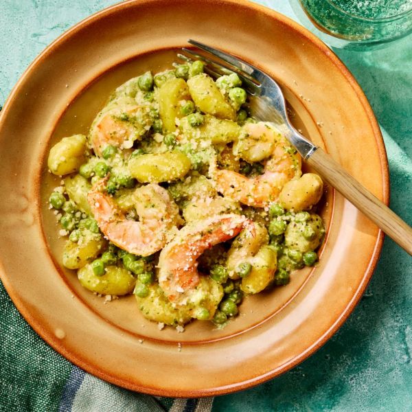 a recipe photo of Creamy Pesto Shrimp with Gnocchi & Peas Credit: Photographer: Greg DuPree, Prop stylist: Shell Royster, Food stylist: Emily Hall