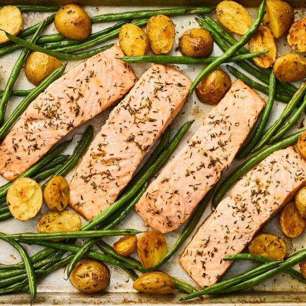A recipe image of Sheet-Pan Roasted Salmon with Potatoes & Green Beans Credit: Photographer: Greg Dupree, Prop Stylist: Claire Spollen, Food Stylist: Chelsea Zimmer.