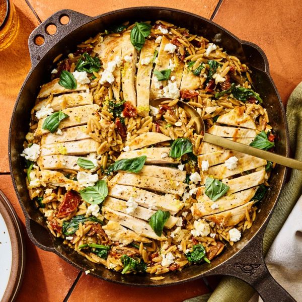 A recipe image of One-Pot Chicken, Spinach & Sun-Dried Tomato Orzo Credit: Photographer: Morgan Hunt Ward, Prop Stylist: Abby Armstrong, Food Stylist: Ruth Skipworth.