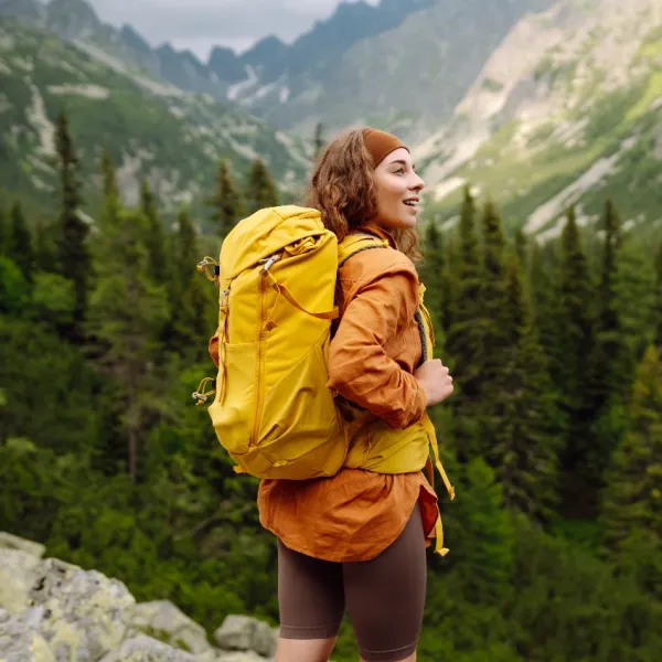 woman feeling satisfied while hiking in the mountains